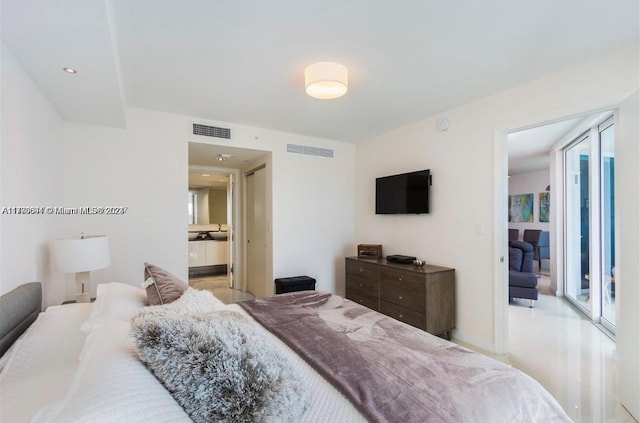 bedroom with ensuite bath and multiple windows