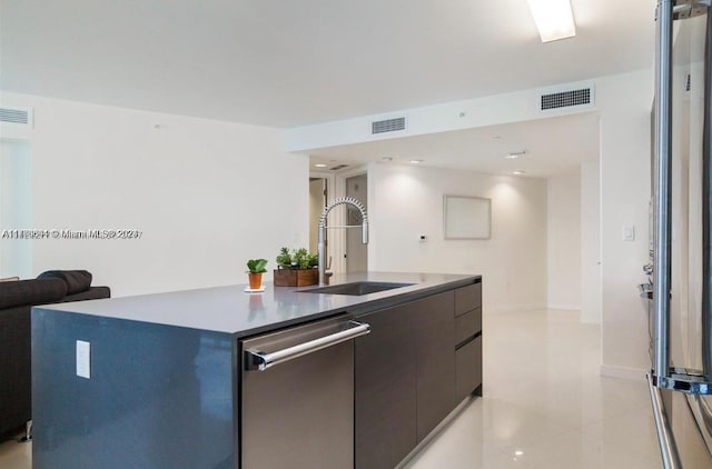 kitchen with dishwasher, light tile patterned flooring, a kitchen island with sink, and sink