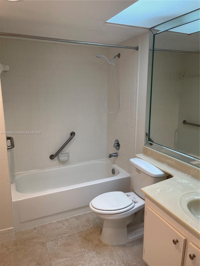 full bathroom with vanity, tiled shower / bath combo, tile patterned floors, and toilet