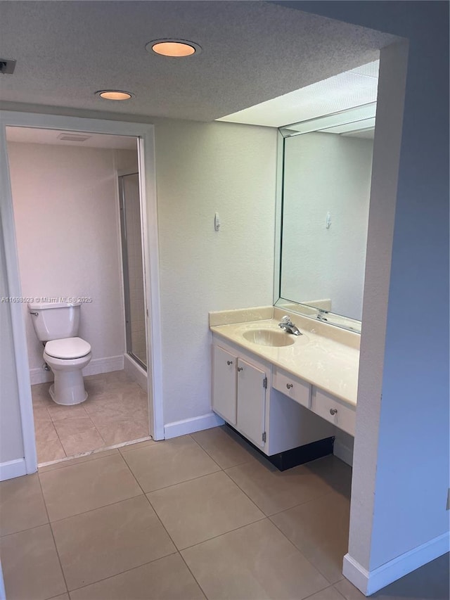 bathroom featuring tile patterned floors, toilet, a shower with shower door, a textured ceiling, and vanity