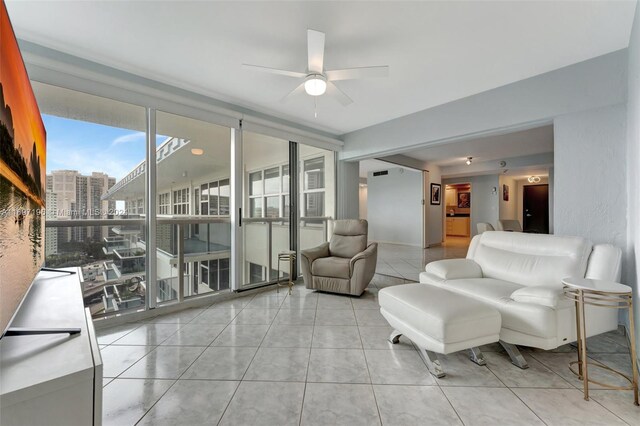 tiled living room featuring ceiling fan