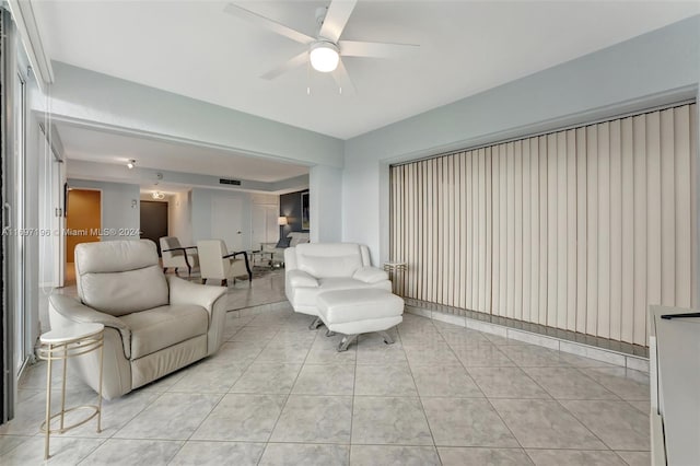 tiled living room with ceiling fan