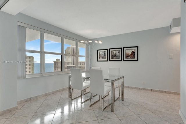 tiled dining space featuring a water view