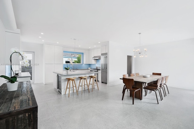 dining space with an inviting chandelier and sink