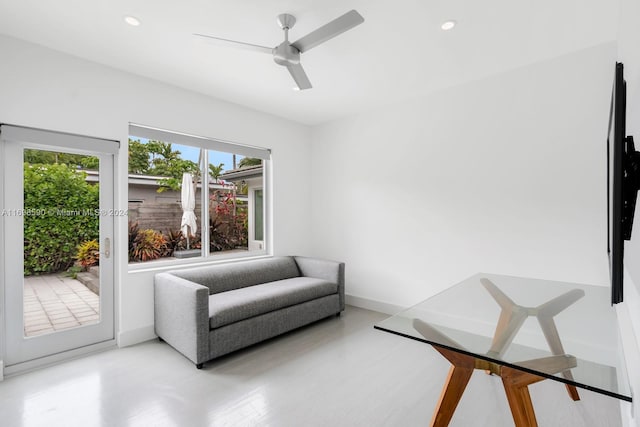 living area featuring hardwood / wood-style flooring and ceiling fan