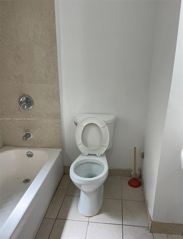 full bath featuring tile patterned flooring, toilet, and baseboards