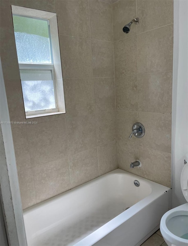 full bath with toilet,  shower combination, and tile patterned floors