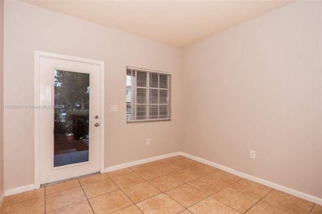 unfurnished room with light tile patterned floors