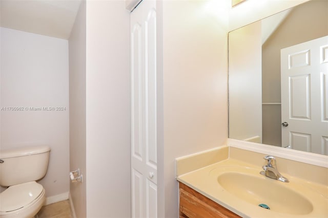 bathroom featuring tile patterned floors, vanity, and toilet