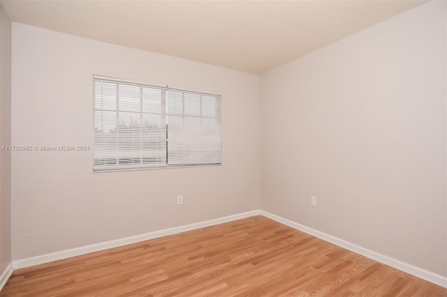 spare room with light hardwood / wood-style flooring