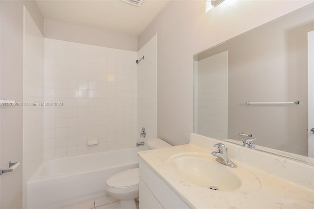 full bathroom featuring tile patterned floors, vanity, tiled shower / bath combo, and toilet