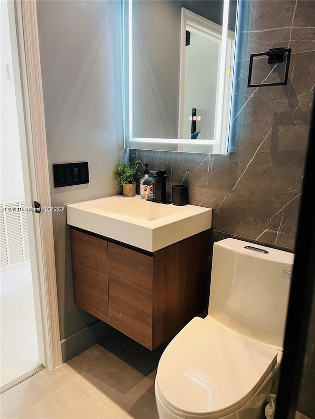 bathroom with tile patterned flooring, vanity, and toilet