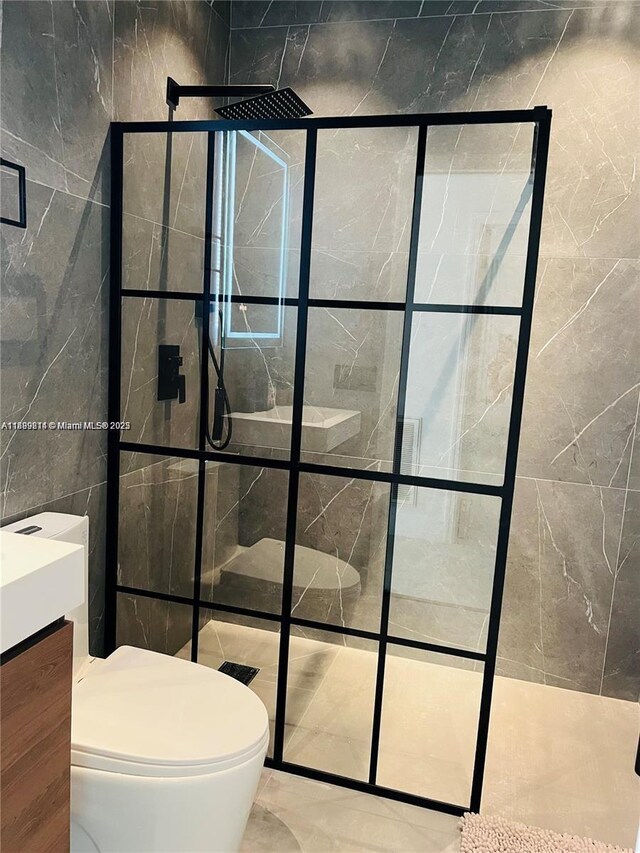 13751 NE 1st Ave, Miami, FL 33161 - bathroom featuring a stall shower, tile walls, marble finish flooring, and vanity