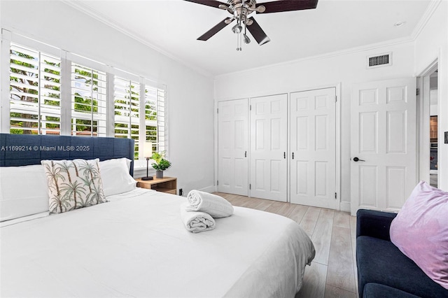 13751 NE 1st Ave, Miami, FL 33161 - bedroom featuring crown molding, light wood-style floors, a closet, and a ceiling fan