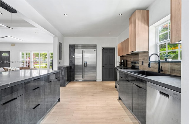 13751 NE 1st Ave, Miami, FL 33161 - kitchen featuring appliances with stainless steel finishes, modern cabinets, light wood finished floors, healthy amount of natural light, and recessed lighting