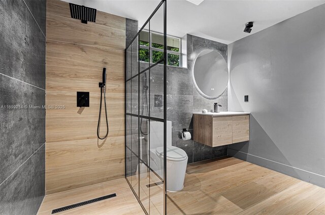 13751 NE 1st Ave, Miami, FL 33161 - bathroom featuring a walk in shower, vanity, tile walls, and wood finished floors