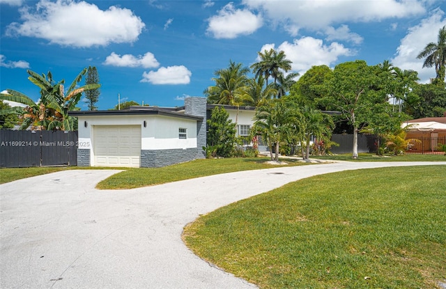 13751 NE 1st Ave, Miami, FL 33161 - view of front of property with stone siding, driveway, stucco siding, and an attached garage