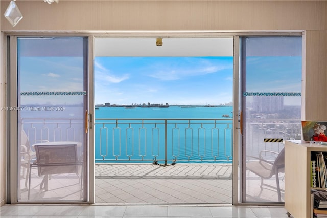 interior space with tile patterned flooring and a water view