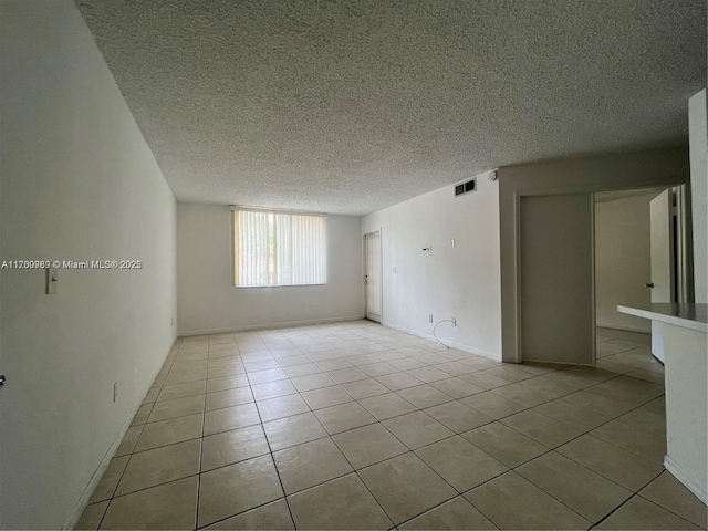 4015 W Mcnab Rd Unit D101, Pompano Beach, FL 33069 - empty room featuring light tile patterned floors and a textured ceiling