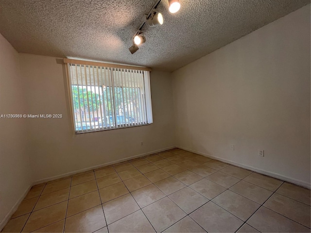 4015 W Mcnab Rd Unit D101, Pompano Beach, FL 33069 - unfurnished room featuring a textured ceiling and light tile patterned floors