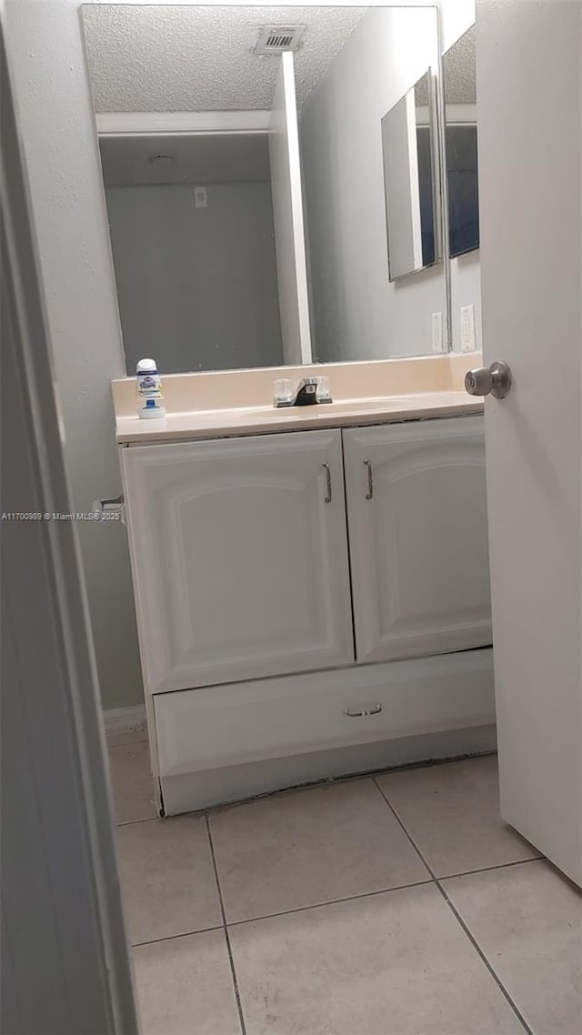 4015 W Mcnab Rd Unit D101, Pompano Beach, FL 33069 - bathroom with tile patterned flooring, vanity, and a textured ceiling