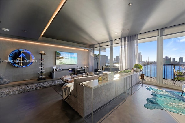 living room with concrete floors and floor to ceiling windows