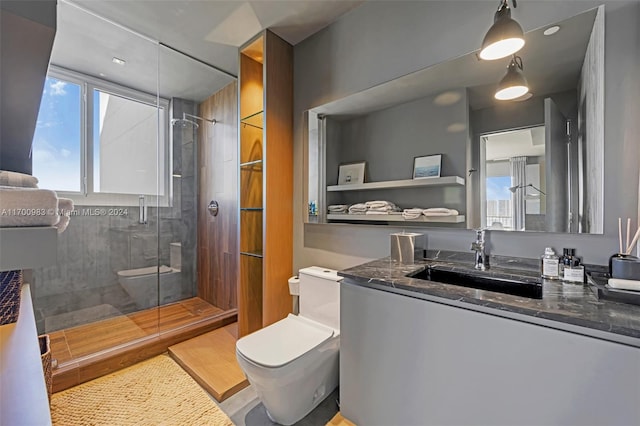 bathroom featuring hardwood / wood-style floors, vanity, a shower with shower door, and toilet