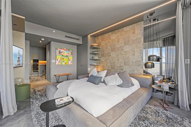 bedroom featuring concrete flooring