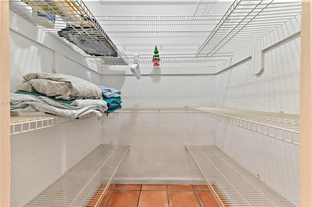 walk in closet with tile patterned flooring