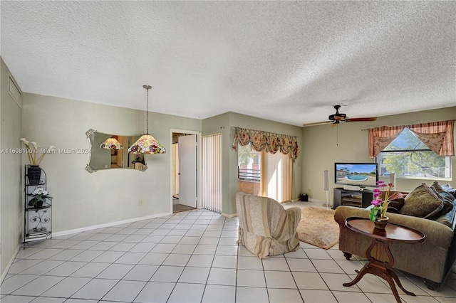 living room featuring a textured ceiling, ceiling fan, and a healthy amount of sunlight