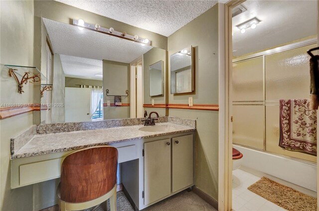 1104 N Hiatus Rd Unit 1104, Pembroke Pines, FL 33026 - kitchen with stainless steel appliances, a textured ceiling, a peninsula, baseboards, and light tile patterned floors