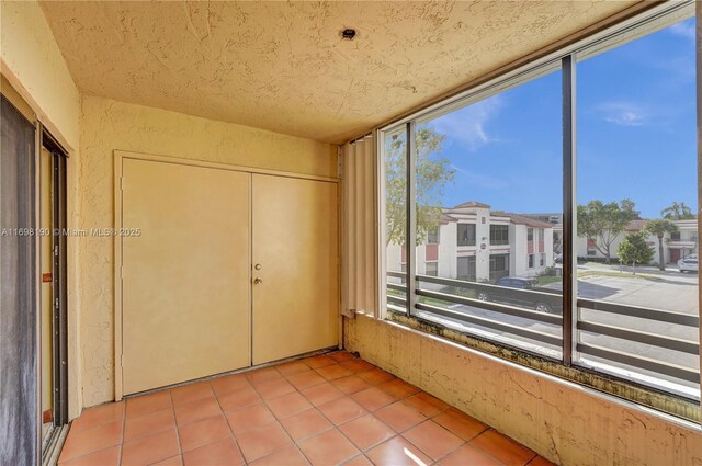 1104 N Hiatus Rd Unit 1104, Pembroke Pines, FL 33026 - kitchen featuring appliances with stainless steel finishes, a sink, tile counters, a textured ceiling, and decorative backsplash