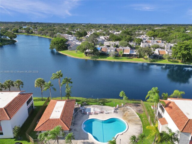 1104 N Hiatus Rd Unit 1104, Pembroke Pines, FL 33026 - kitchen featuring a textured ceiling, a peninsula, light tile patterned flooring, tile countertops, and a ceiling fan