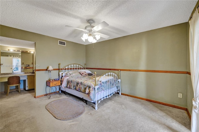 bedroom featuring light carpet, a textured ceiling, and ceiling fan