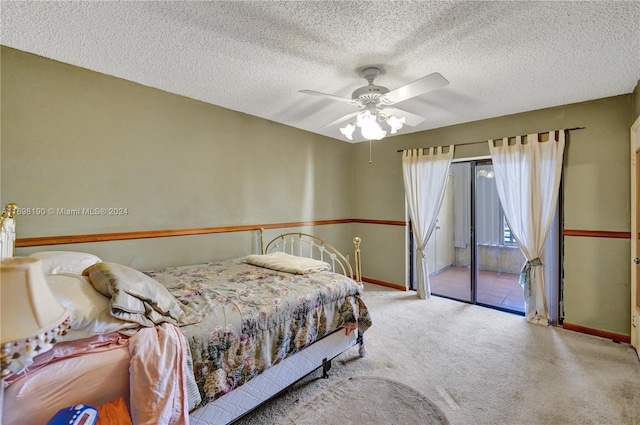 carpeted bedroom with ceiling fan, access to exterior, and a textured ceiling