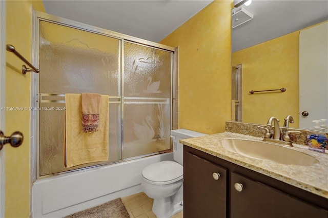 full bathroom with tile patterned floors, vanity, toilet, and shower / bath combination with glass door