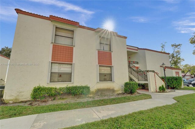 1104 N Hiatus Rd Unit 1104, Pembroke Pines, FL 33026 - laundry area with washer / clothes dryer, electric water heater, healthy amount of natural light, and light tile patterned floors