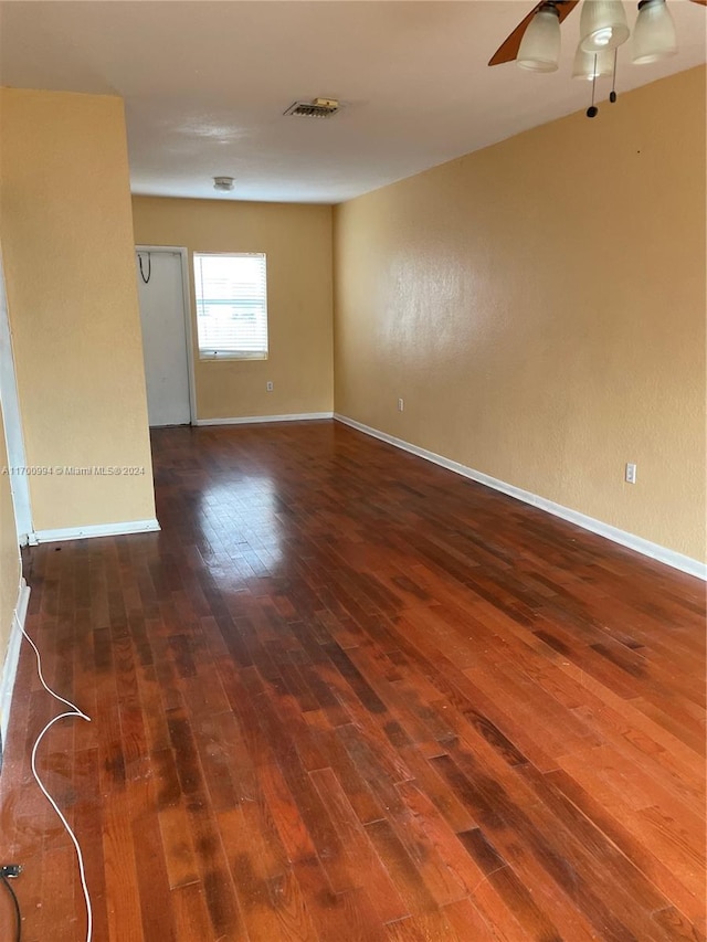 spare room with ceiling fan and dark hardwood / wood-style floors