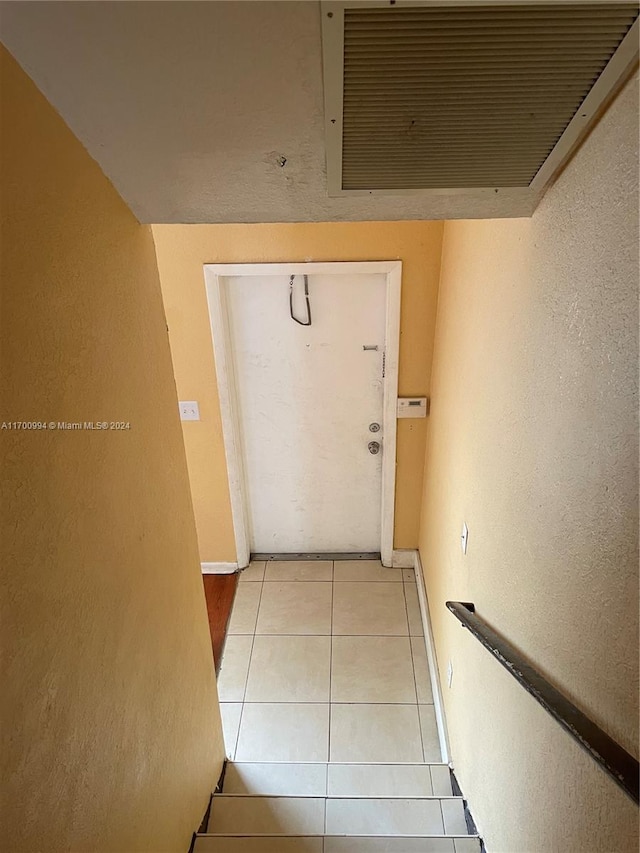 hallway featuring light tile patterned floors