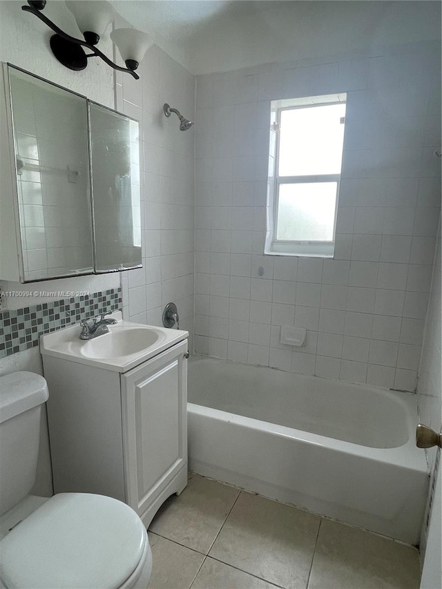 full bathroom with decorative backsplash, tile patterned floors, vanity, tiled shower / bath combo, and tile walls