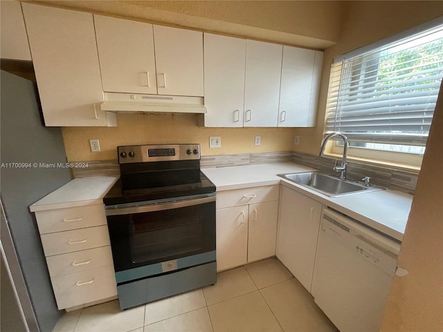 kitchen featuring light tile patterned floors, stainless steel appliances, white cabinetry, and sink