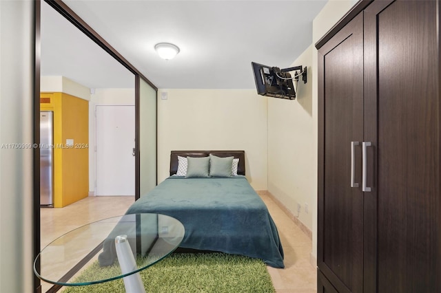 bedroom with stainless steel refrigerator