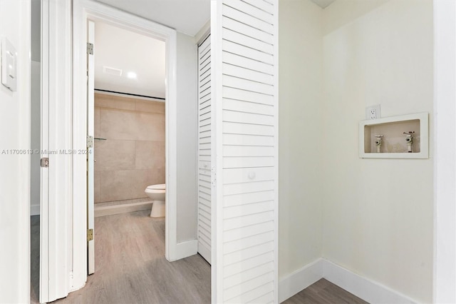 washroom featuring washer hookup and light hardwood / wood-style floors