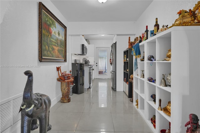 hall with light tile patterned floors