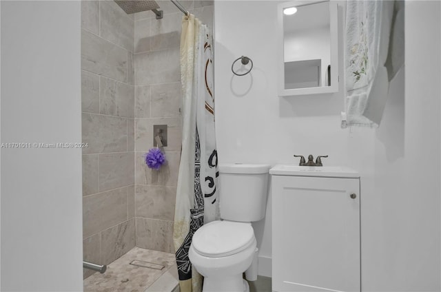 bathroom with curtained shower, vanity, and toilet