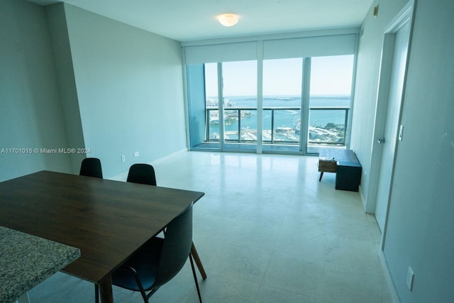 office with floor to ceiling windows and a water view