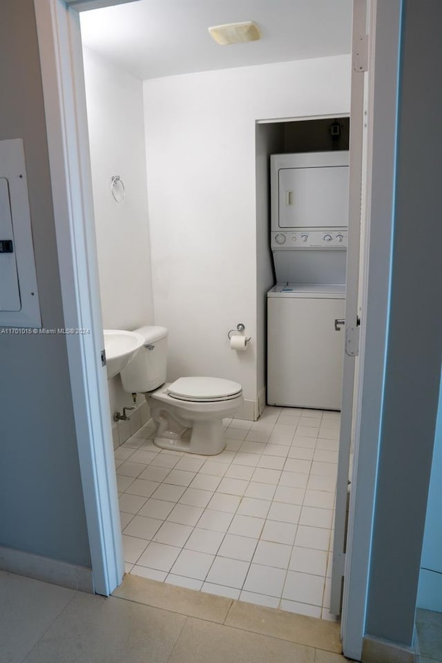 888 Biscayne Blvd Unit 3806, Miami, FL 33132 - bathroom featuring stacked washer / dryer, toilet, tile patterned flooring, and electric panel