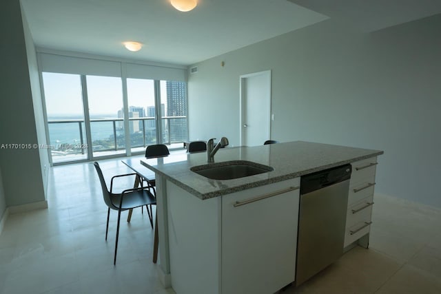 888 Biscayne Blvd Unit 3806, Miami, FL 33132 - kitchen featuring stainless steel dishwasher, a sink, expansive windows, white cabinets, and light stone countertops