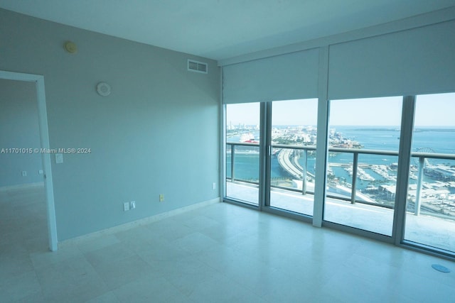 unfurnished room with a water view