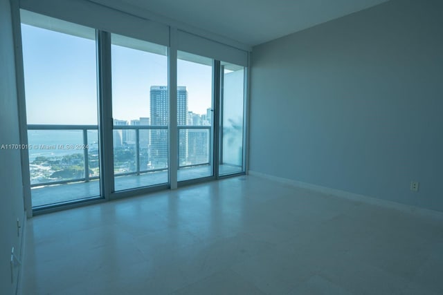888 Biscayne Blvd Unit 3806, Miami, FL 33132 - unfurnished room with floor to ceiling windows, a city view, and baseboards